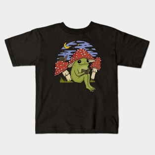 A Cute Frog in Mushroom Cap, Reading Amongst Snails and Toadstools, Embracing Goblincore Charm Kids T-Shirt